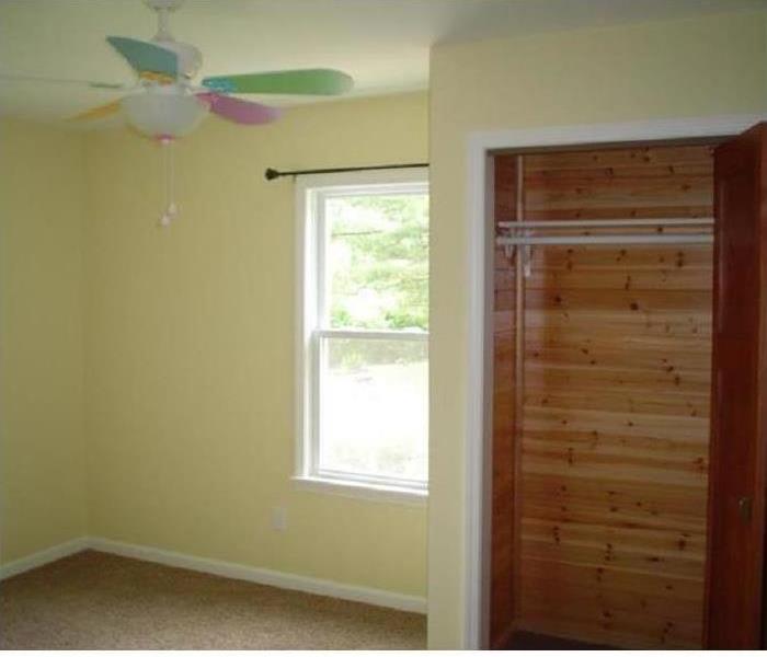 the bedroom, rebuilt, a new room with carpet, painted walls and a ceiling fan