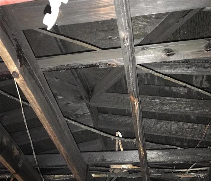 charred and burnt rafters in an attic
