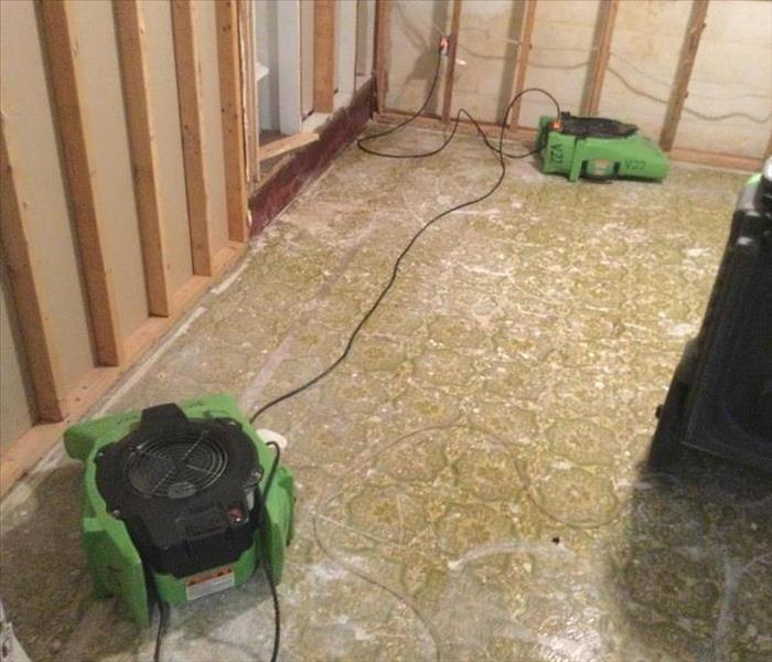 Drying equipment is setup in a room that is demoed to remove mold.