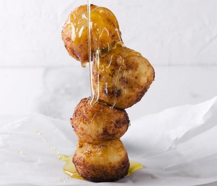 Deep fried donuts with honey. 